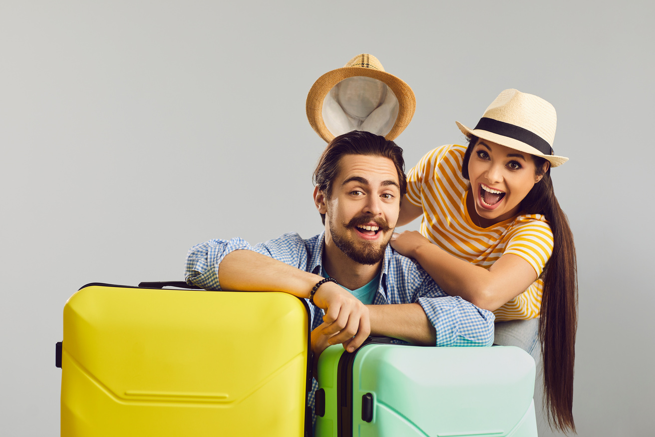 Overjoyed Funny Couple Traveler with Luggage Bag Studio Headshot Portrait